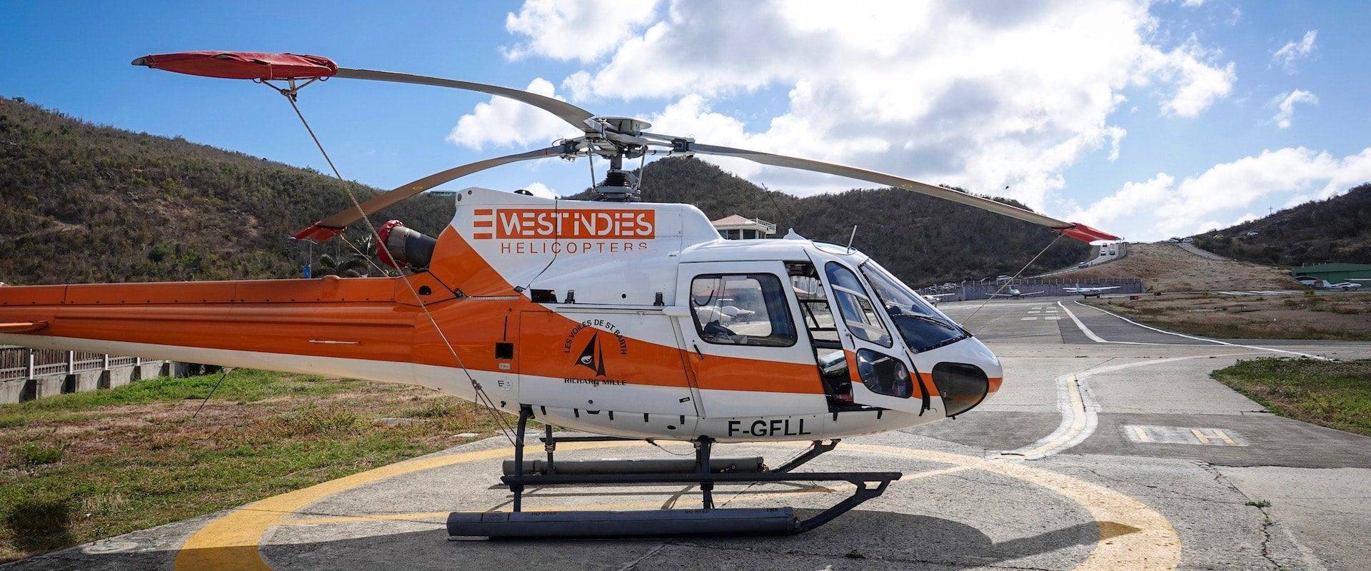 Helicopter flying between St Martin and St Barth over turquoise Caribbean waters