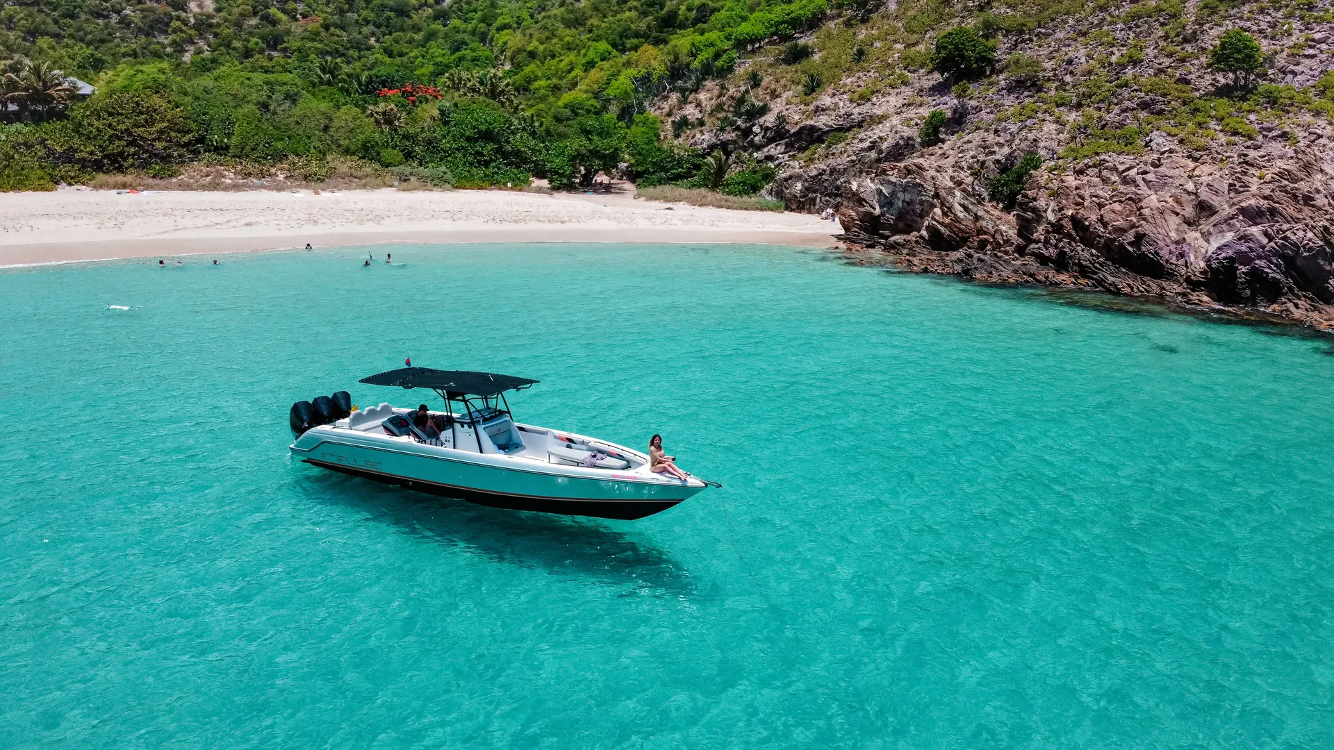 A day boat anchored in a turquoise cove, St Barth